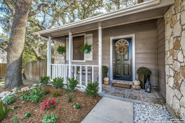 view of exterior entry featuring a porch