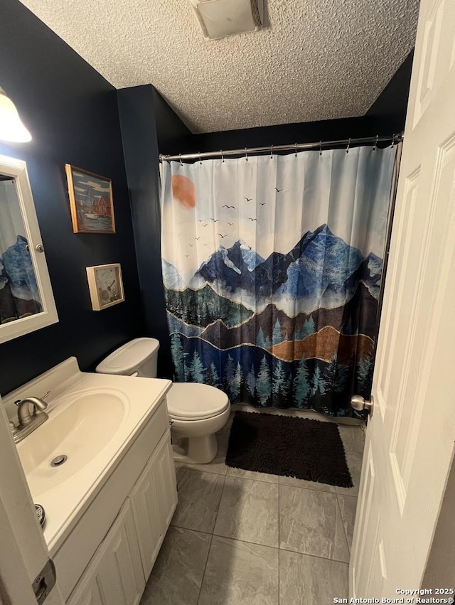 bathroom with vanity, toilet, a shower with shower curtain, and a textured ceiling