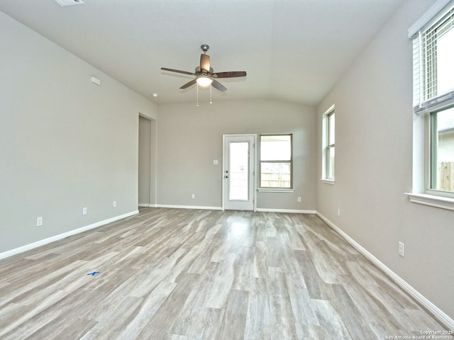 spare room featuring vaulted ceiling, ceiling fan, and light hardwood / wood-style floors