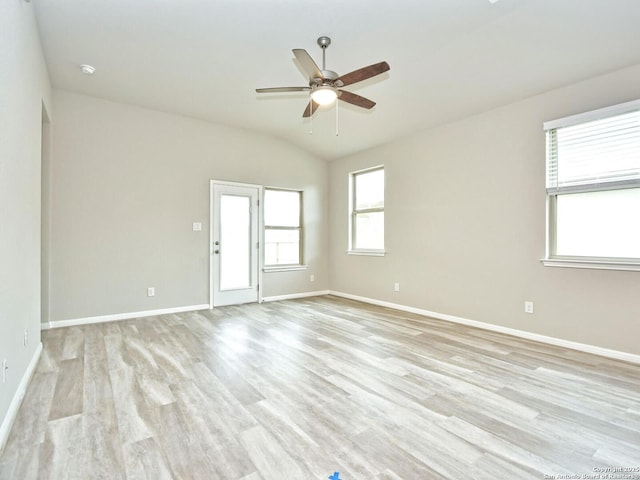 spare room featuring vaulted ceiling, ceiling fan, and light hardwood / wood-style floors