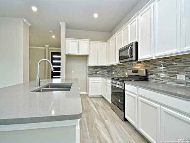 kitchen featuring white cabinetry, sink, and appliances with stainless steel finishes