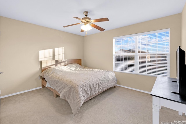 bedroom featuring light carpet and ceiling fan