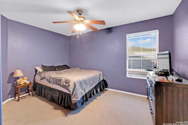 bedroom with ceiling fan and light carpet