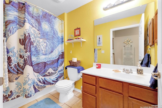 bathroom with tile patterned flooring, vanity, and toilet