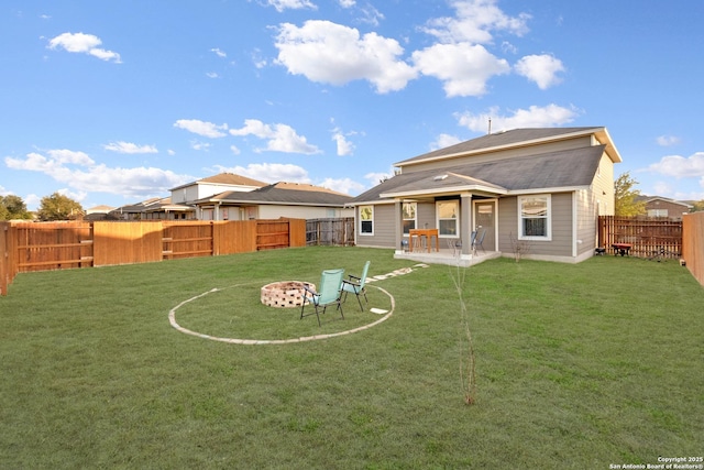 back of house featuring a patio area and a lawn