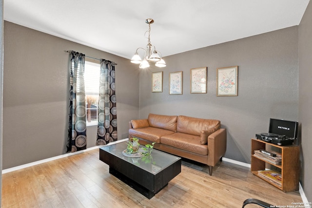 living room with hardwood / wood-style flooring and a notable chandelier