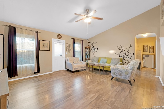 living room featuring ceiling fan, lofted ceiling, and light hardwood / wood-style floors