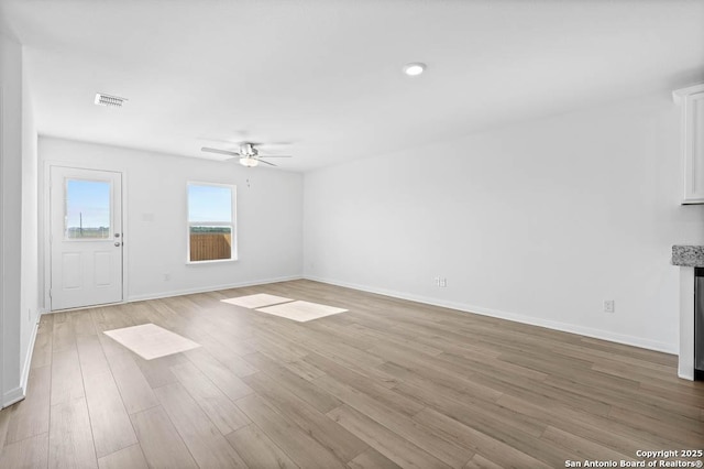 unfurnished living room with ceiling fan and light wood-type flooring