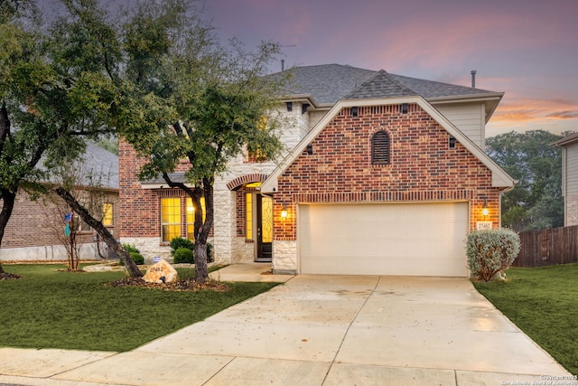 view of property featuring a yard and a garage