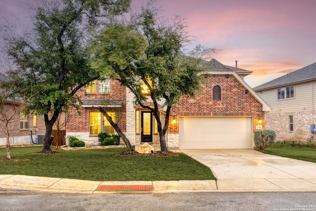 view of front of home with a garage and a lawn