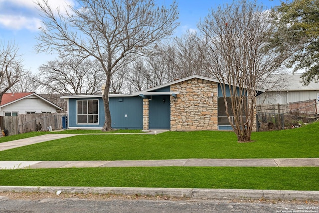 view of front of home with a sunroom and a front yard