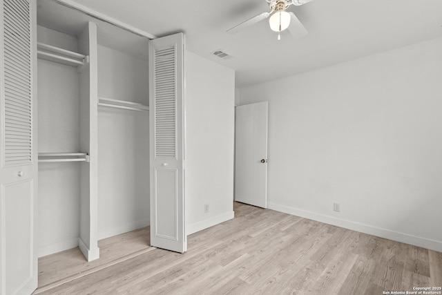 unfurnished bedroom featuring a closet, ceiling fan, and light wood-type flooring