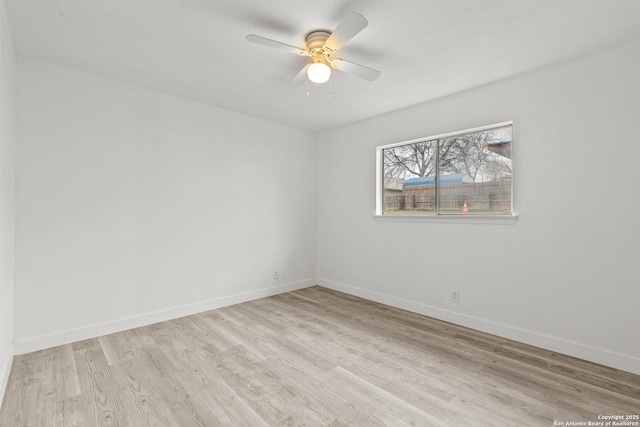 empty room with ceiling fan and light hardwood / wood-style flooring