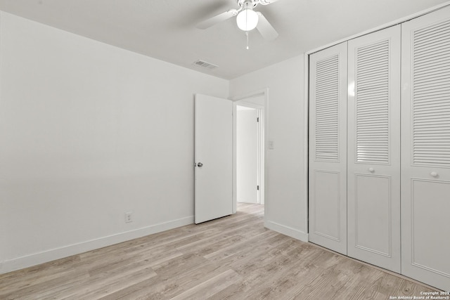 unfurnished bedroom featuring a closet, ceiling fan, and light wood-type flooring