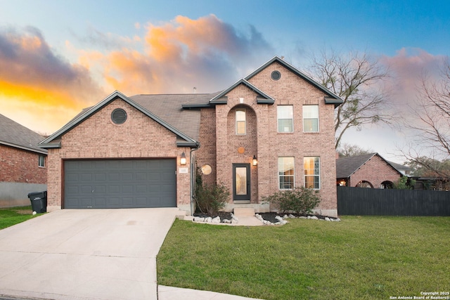 view of front property with a garage and a lawn