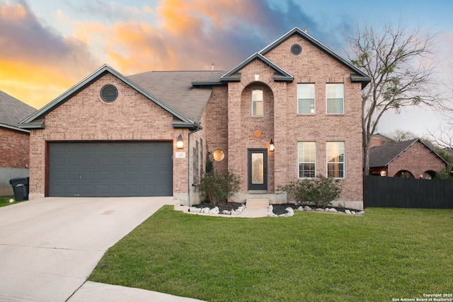 view of property featuring a yard and a garage