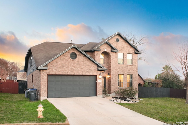 front of property featuring a garage and a lawn