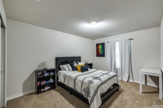 carpeted bedroom featuring a textured ceiling