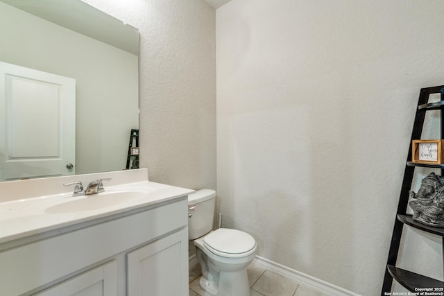 bathroom featuring vanity, tile patterned floors, and toilet