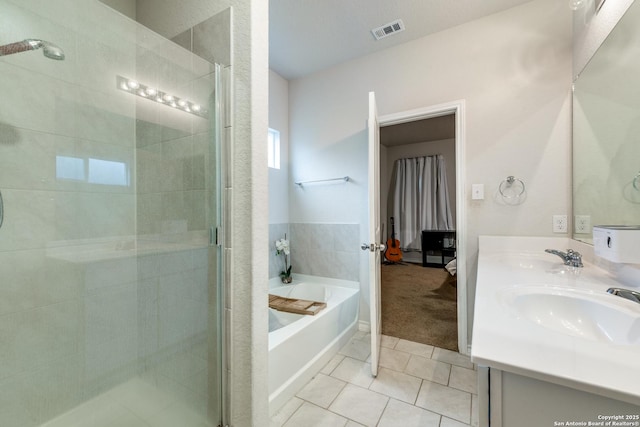 bathroom featuring vanity, plus walk in shower, and tile patterned flooring