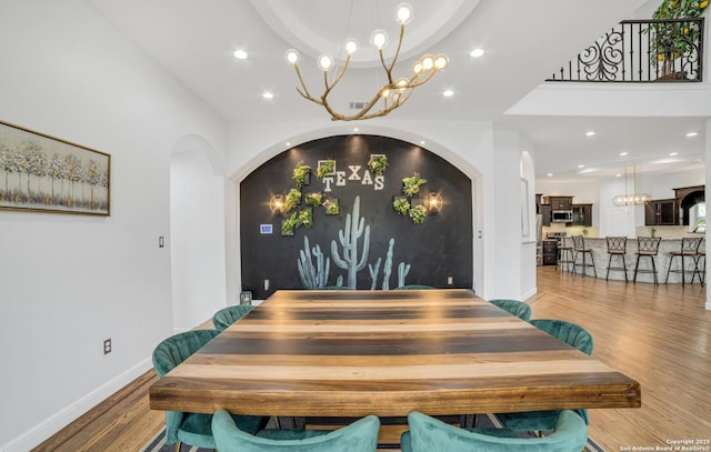 dining room with a notable chandelier and light wood-type flooring