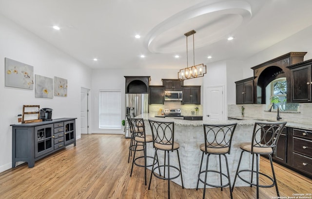 kitchen with dark brown cabinets, stainless steel appliances, and a kitchen island