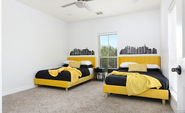 bedroom featuring ceiling fan and carpet