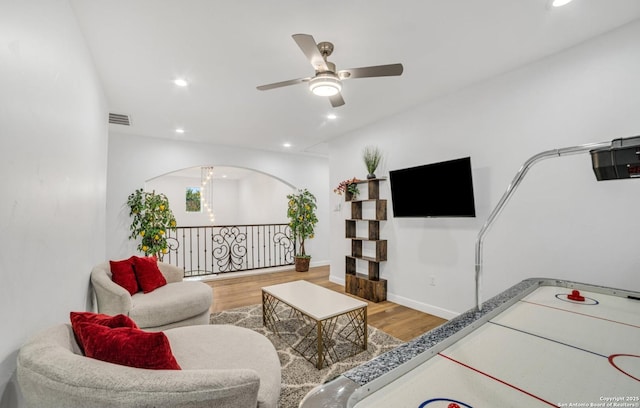 living room featuring ceiling fan and wood-type flooring