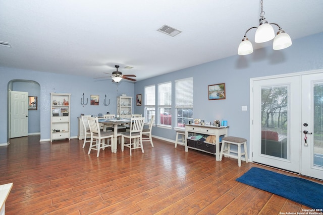 dining area with dark hardwood / wood-style floors, ceiling fan, and french doors