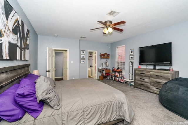 carpeted bedroom with a textured ceiling and ceiling fan