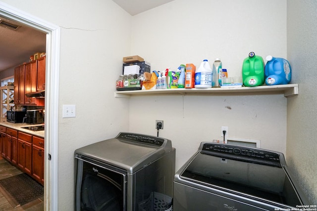 clothes washing area with washer and dryer