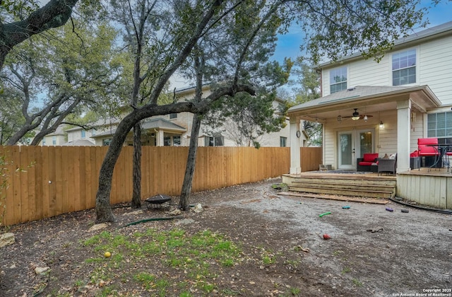 view of yard with french doors and ceiling fan