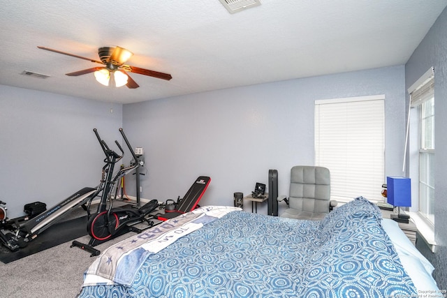 bedroom featuring ceiling fan and a textured ceiling