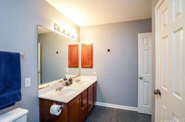 bathroom featuring vanity, hardwood / wood-style flooring, and toilet