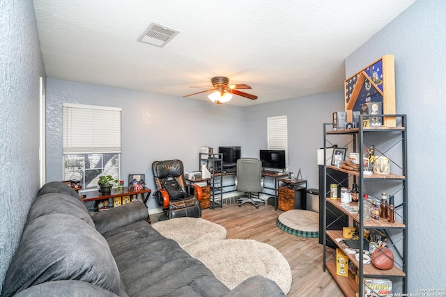 office area with light hardwood / wood-style flooring and ceiling fan