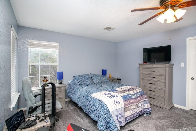 bedroom with a textured ceiling, carpet floors, and ceiling fan