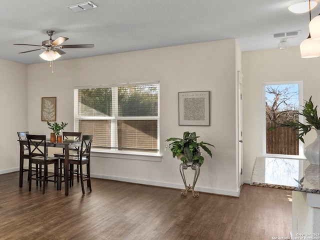 dining space featuring ceiling fan and dark hardwood / wood-style flooring