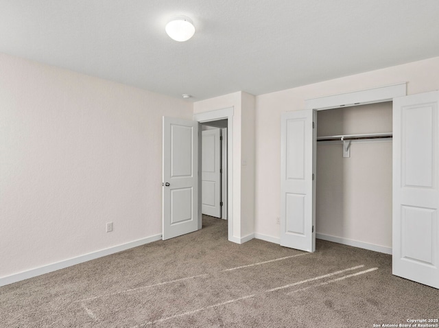 unfurnished bedroom with carpet floors and a closet