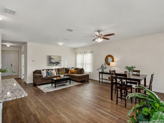 living room with ceiling fan and dark hardwood / wood-style floors