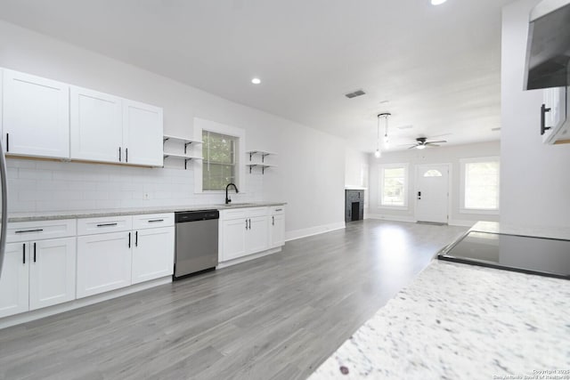 kitchen featuring backsplash, stainless steel dishwasher, sink, and white cabinets