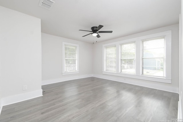 unfurnished room featuring dark hardwood / wood-style flooring and ceiling fan