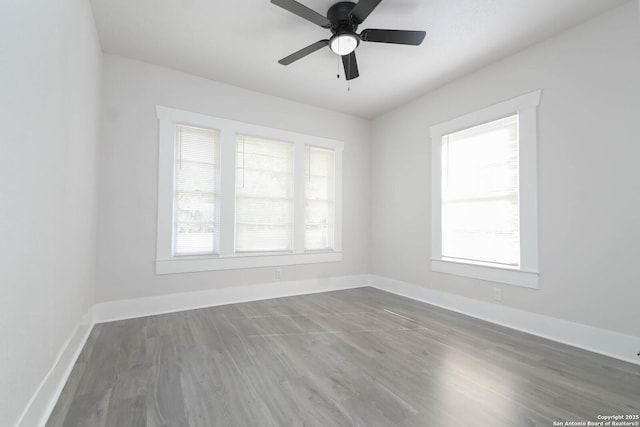 spare room with dark hardwood / wood-style floors and ceiling fan