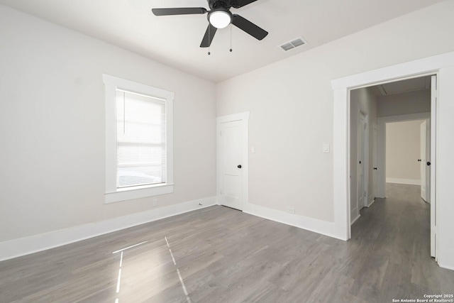 empty room featuring ceiling fan and dark hardwood / wood-style floors