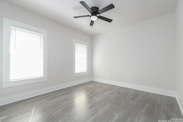 unfurnished room featuring dark hardwood / wood-style floors and ceiling fan