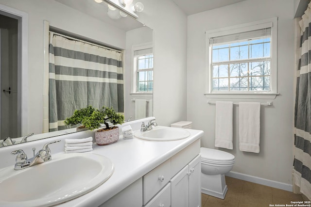 bathroom with a shower with curtain, vanity, tile patterned floors, and toilet