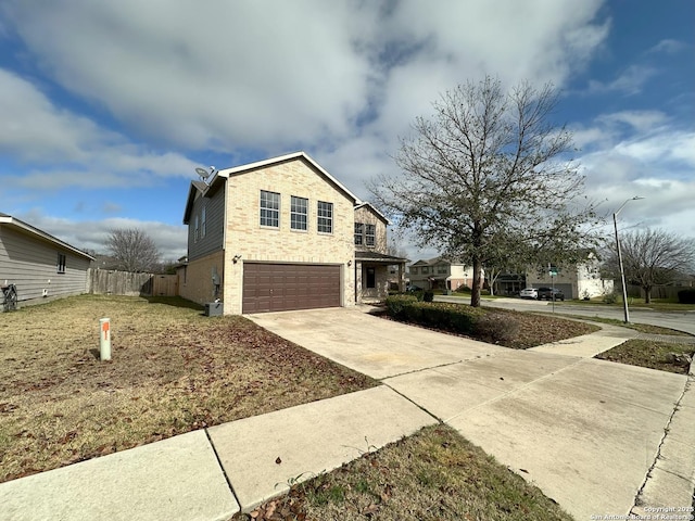 view of front of house featuring a garage and a front lawn