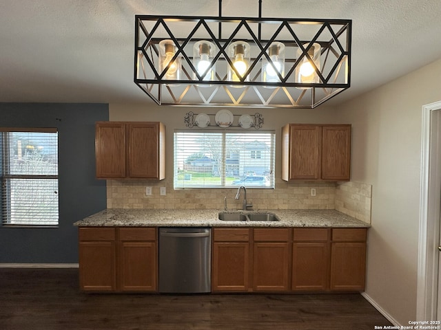 kitchen with dark hardwood / wood-style floors, dishwasher, sink, and backsplash