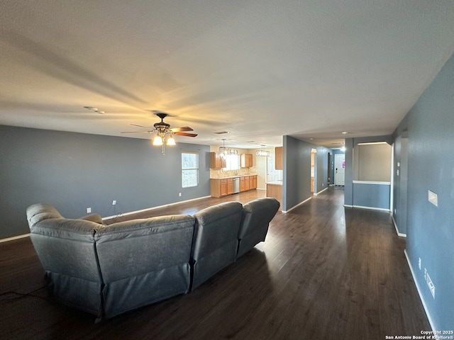 living room with dark wood-type flooring and ceiling fan