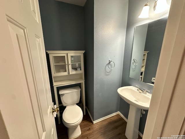 bathroom with hardwood / wood-style floors, sink, and toilet