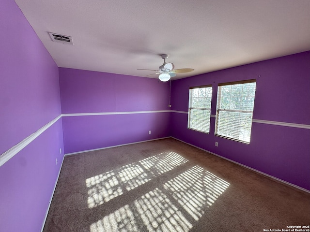 spare room featuring carpet floors and ceiling fan